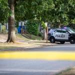 An Everett police officer stands across the street from a home surrounded by crime scene tape along Baker Avenue on Tuesday, Aug. 22, 2023 in Everett, Washington. (Olivia Vanni / The Herald)