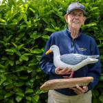 Lawrence E. O’Donnell poses for a photo with Sammy the Seagull, gifted by a friend, at his brother Jack’s home in Everett, Washington on Wednesday, May 29, 2024. (Annie Barker / The Herald)