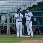 AquaSox infielder Austin St. Laurent (left) stands at first base next to bench coach Logan Moore amid his 5-for-5 performance during a 16-2 win against the Spokane Indians at Everett Memorial Stadium on Aug. 11, 2026. (Joe Pohoryles / The Herald)