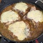 Shredded Gruyère or Swiss cheese can be melted over the tops of the pork chops. (Roy Mosby)
