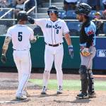 Luis Suisbel #8 of the Everett AquaSox high fives Korbyn Dickerson #5 of the Everett AquaSox after his two-run home run during the game against the Spokane Indians on Thursday, Aug. 13, 2026 in Everett, Washington. (Olivia Vanni / The Herald)