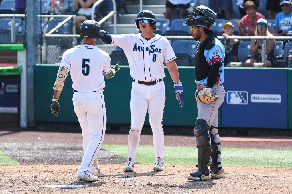 Luis Suisbel #8 of the Everett AquaSox high fives Korbyn Dickerson #5 of the Everett AquaSox after his two-run home run during the game against the Spokane Indians on Thursday, Aug. 13, 2026 in Everett, Washington. (Olivia Vanni / The Herald)